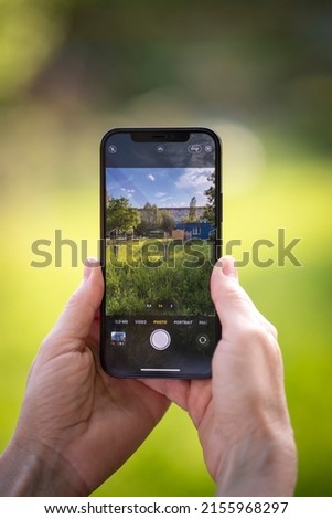 Hands of elderly man taking photo using a phone