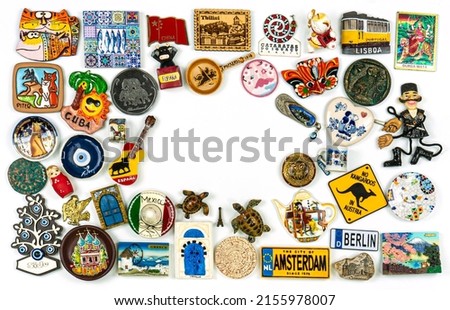 Travel souvenirs From Around The World On A White Background. Fridge magnets. Landscape orientation with window. Royalty-Free Stock Photo #2155978007
