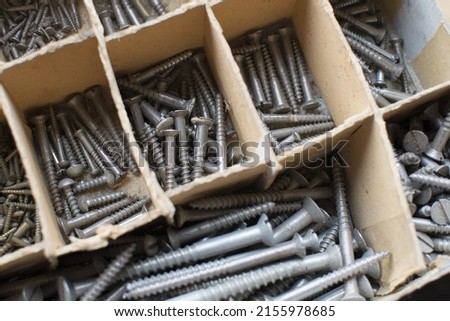 tapping screws made od steel, metal screw, iron screw, chrome screw, screws as a background, wood screw,  Royalty-Free Stock Photo #2155978685