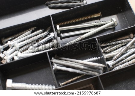 tapping screws made od steel, metal screw, iron screw, chrome screw, screws as a background, wood screw,  Royalty-Free Stock Photo #2155978687