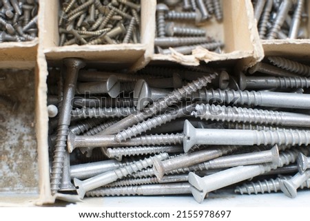 tapping screws made od steel, metal screw, iron screw, chrome screw, screws as a background, wood screw,  Royalty-Free Stock Photo #2155978697