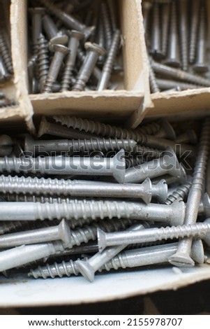 tapping screws made od steel, metal screw, iron screw, chrome screw, screws as a background, wood screw,  Royalty-Free Stock Photo #2155978707