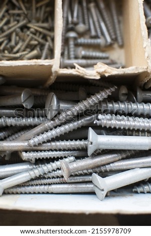 tapping screws made od steel, metal screw, iron screw, chrome screw, screws as a background, wood screw,  Royalty-Free Stock Photo #2155978709