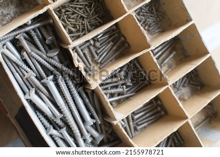 tapping screws made od steel, metal screw, iron screw, chrome screw, screws as a background, wood screw,  Royalty-Free Stock Photo #2155978721