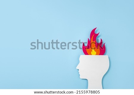 Multi-colored cardboard application of the silhouette of human head and flame. Minimal concept of psychological and emotional burnout. Сopy space
