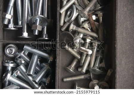 tapping screws made od steel, metal screw, iron screw, chrome screw, screws as a background, wood screw,  Royalty-Free Stock Photo #2155979115