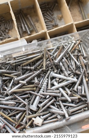 tapping screws made od steel, metal screw, iron screw, chrome screw, screws as a background, wood screw,  Royalty-Free Stock Photo #2155979123
