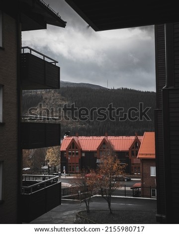 A vertical shot of a beautiful rural area with motel buildings or houses in the mountains Royalty-Free Stock Photo #2155980717