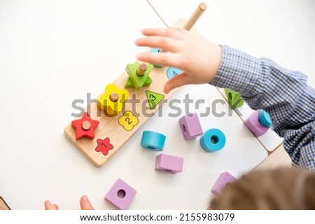 Learning counting, shapes and colors. Montessori type implement. wooden toys. Royalty-Free Stock Photo #2155983079