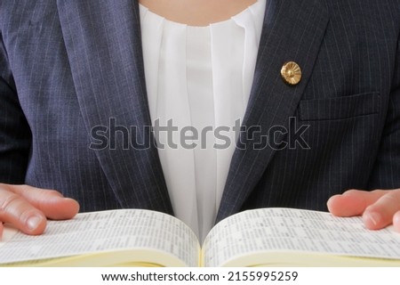 A Japanese female lawyer reading a legal book