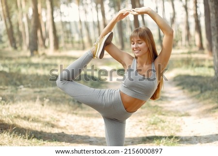 Cute girl doing yoga in a summer forest