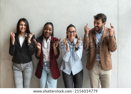 Group of multiethnic young business freelance people hopeful crossing their fingers hoping, asking for best. Human success face expressions, emotions, feelings attitude reaction