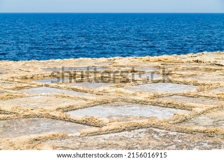 Xwejni salt pans next to the sea pictured on the island of Gozo, Malta.
