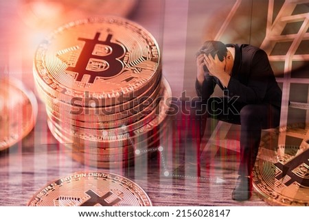 stressed sad businessman with a strain of bitcoin digital stock market graph bar. Cryptocurrency. Bitcoin Stock down. Investing in virtual assets. Investment platform with charts and bitcoin coin. Royalty-Free Stock Photo #2156028147
