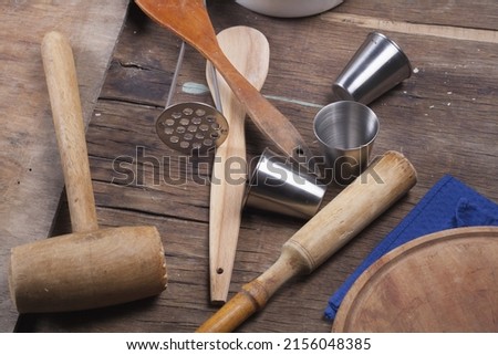 Old vintage kitchen tools on brown wooden background