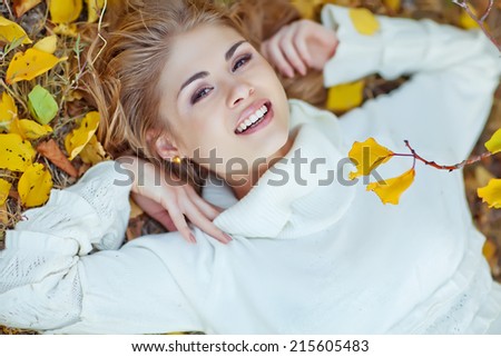 Portrait of beautiful young woman walking outdoors in autumn