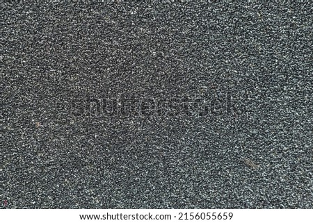 black rough surface The surface of the sandpaper is rough and coarse. rough texture background Royalty-Free Stock Photo #2156055659