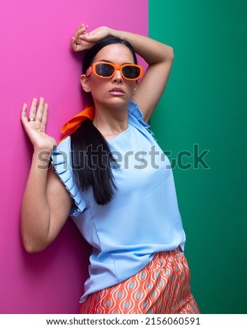 Beautiful modern and elegant fashion  woman, a girl in the style of the sixties posing on a copy background