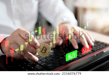 Businessman analysing economic growth graph of bitcoin, Cryptocurrency or blockchain data on laptop. Stock market investment. Financial and banking Technology. Golden bitcoin, trading stock chart.