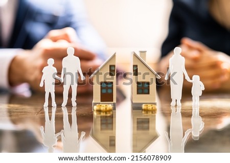 Wife And Husband Splitting Children And House During Divorce Process Royalty-Free Stock Photo #2156078909