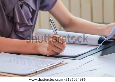 young woman is reviewing the lessons to understand and learn the information in the textbooks she will need to prepare for the exam. The concept of reading the lessons in the book to understand. Royalty-Free Stock Photo #2156084695
