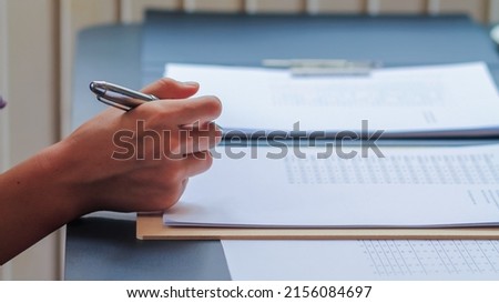 young woman is reviewing the lessons to understand and learn the information in the textbooks she will need to prepare for the exam. The concept of reading the lessons in the book to understand. Royalty-Free Stock Photo #2156084697