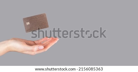 Hand and levitating credit card mock up on banner, background with copy space for text. Royalty-Free Stock Photo #2156085363