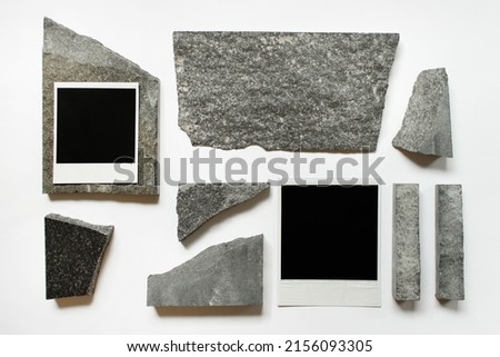 Abstract composition with two polaroid cards and random sized stones on white background. Royalty-Free Stock Photo #2156093305