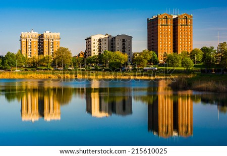 Reflections of buildings in Druid Lake, at Druid Hill Park, in Baltimore, Maryland.
