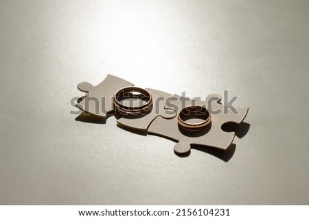 Wedding rings and puzzle pieces. Husband and wife complement each other perfectly.