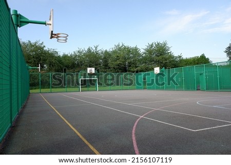 Multi-use sports court with basketball nets and football goals Royalty-Free Stock Photo #2156107119