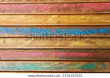 Colored wood texture with some imperfections and grooves. Rustic wooden boards with colors. Top view.