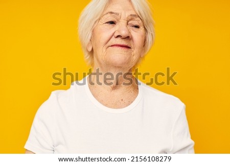 Portrait of an old friendly woman posing face grimace joy cropped view