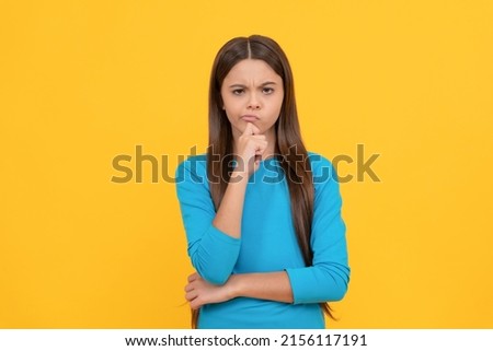 female fashion model. pretty look of young girl. face portrait of child on yellow background.