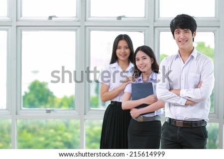 Asia students read a book  in Library with uniform Royalty-Free Stock Photo #215614999