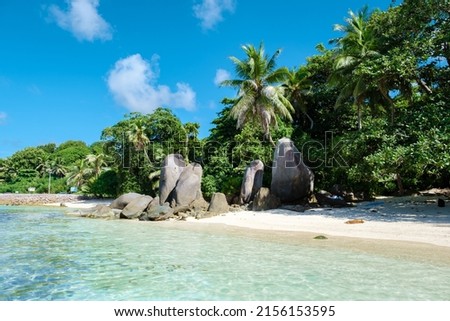 Mahe Seychelles, a tropical beach with palm trees, and a blue ocean at Mahe Seychelles. Anse Royale beach Seychelles Mahe