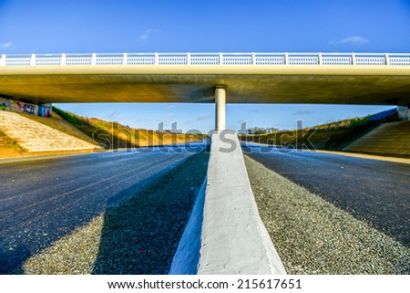 A new highway with security barrier closeup under modern new bridge