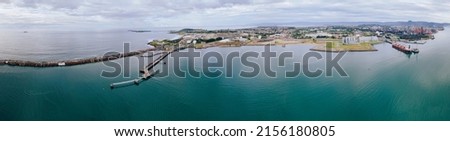 Aerial drone panoramic view of Port Kembla, in the Illawarra Region of NSW, showing the seaport, industrial complex and small harbour foreshore    Royalty-Free Stock Photo #2156180805
