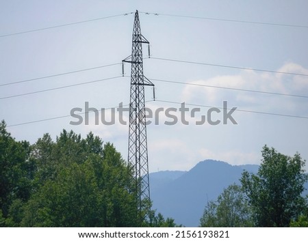 Picture of an anchor pylon tower with the hills in the background and the trees in the foreground.