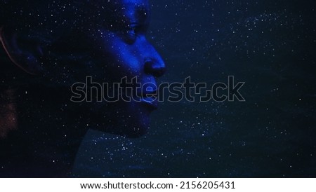 Human universe. Cosmic portrait. Dream consciousness. Neon blue closeup profile silhouette of mysterious woman face on dark night stardust wrinkled texture copy space background.