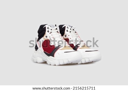 White sport high soled women's basketball shoes, sneakers, 
sports shoes, boots for female isolated on white background. Footwear, pair of running training shoes, side view Royalty-Free Stock Photo #2156215711
