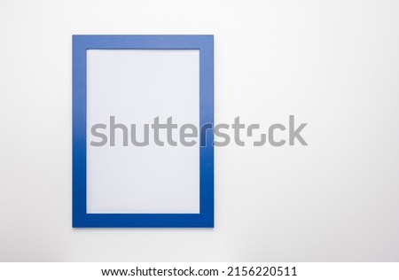 upright photo frame mockup on white wall. blank diploma frame on white wall background. Picture frame mockup. blank diploma frame on white wall background. Size 50x70, 20x28, a3, a4, copy space Royalty-Free Stock Photo #2156220511