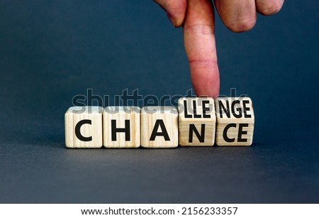 Chance or challenge symbol. Businessman turns wooden cubes and changes the concept word challenge to chance. Beautiful grey table grey background. Business challenge or chance concept. Copy space.
