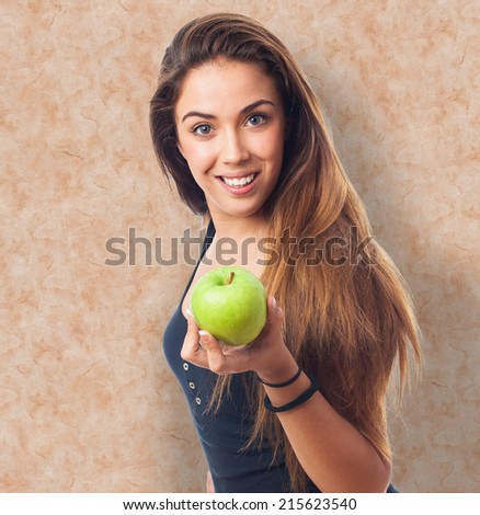 portrait of a young woman holding a green apple