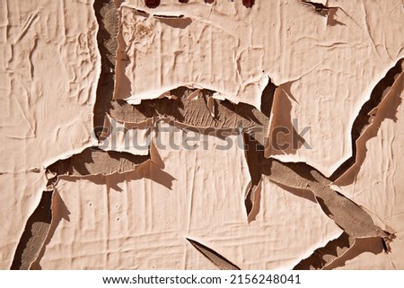Cracked paint texture. Grunge wall texture. Dark wall with old paint. The wall is crumbling with age.