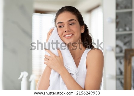 Morning Skincare Routine. Happy Female Drying Face With Soft Towel Standing In Modern Bathroom Indoor. Beauty Care And Facial Skin Care Cosmetics, Wellness And Pampering Concept Royalty-Free Stock Photo #2156249933