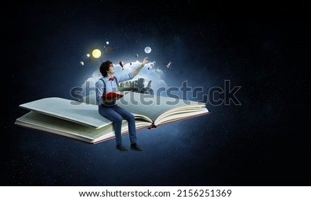 World of books concept with a student Royalty-Free Stock Photo #2156251369