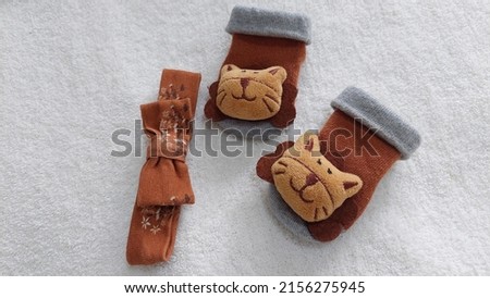 Brown baby head band and socks on white background