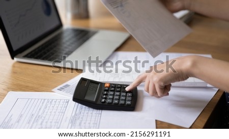 Accountant woman calculating expenses, fees, analyzing financial reports, counting money, company budget, costs, reviewing bills, checking taxes, vat. Banner shot, close up of hands Royalty-Free Stock Photo #2156291191