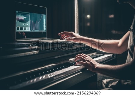 A man composer, producer, arranger, songwriter, musician hands arranging music. Royalty-Free Stock Photo #2156294369